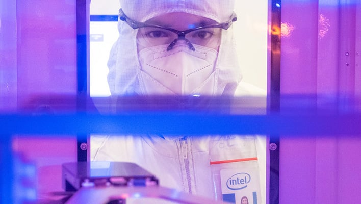 Intel engineer staring into a machine.